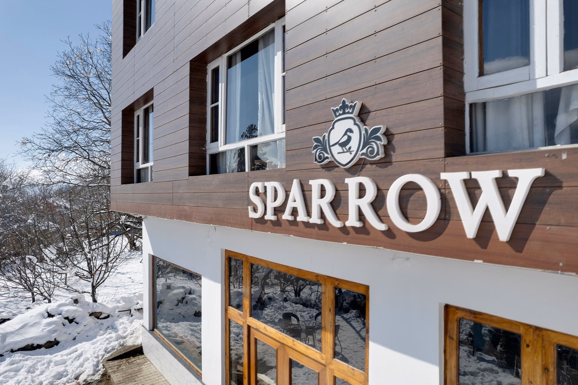 Hotel Sparrow signage and crest detail on the facade