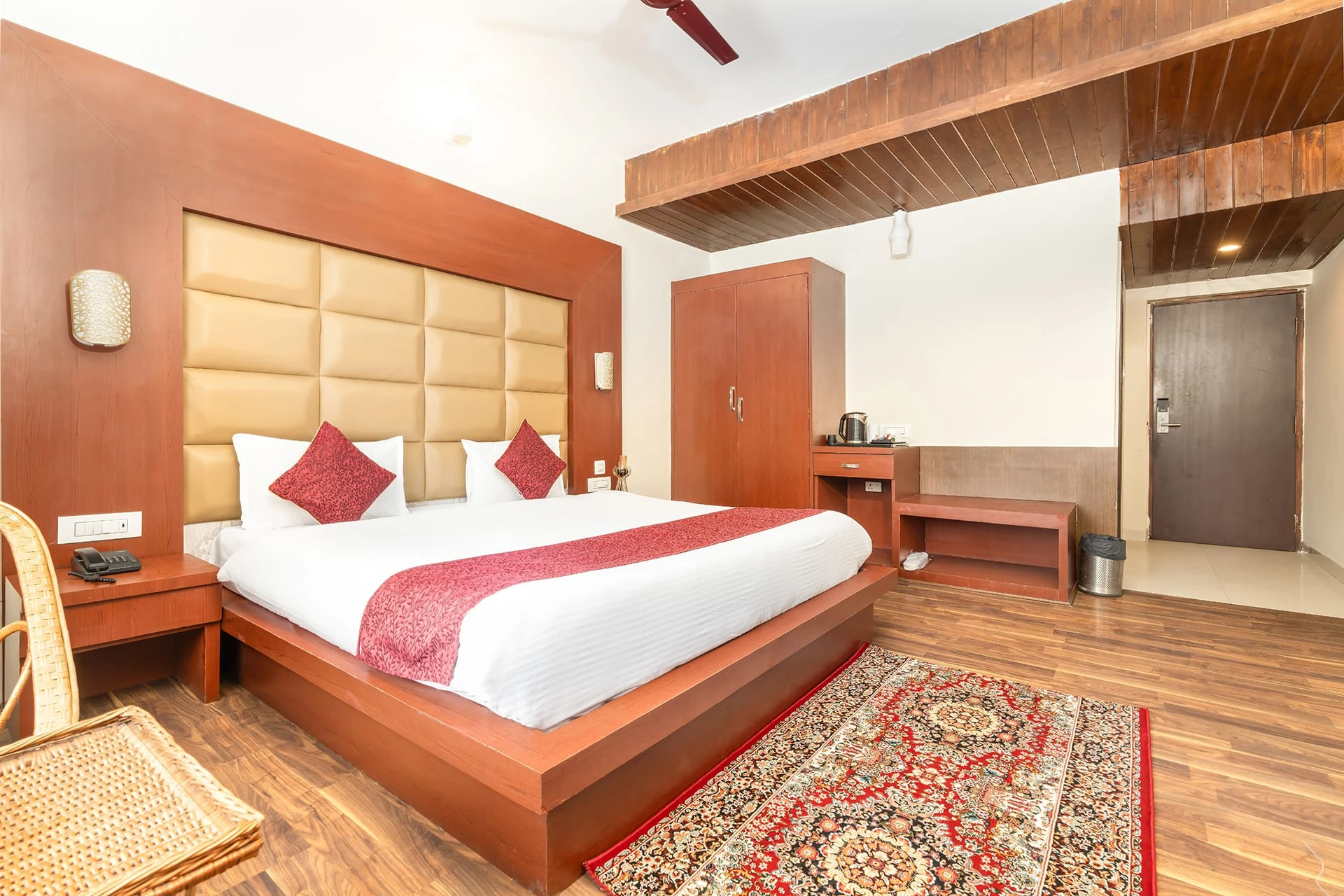 Deluxe Premier room at Hotel Sparrow with warm wood tones and village view