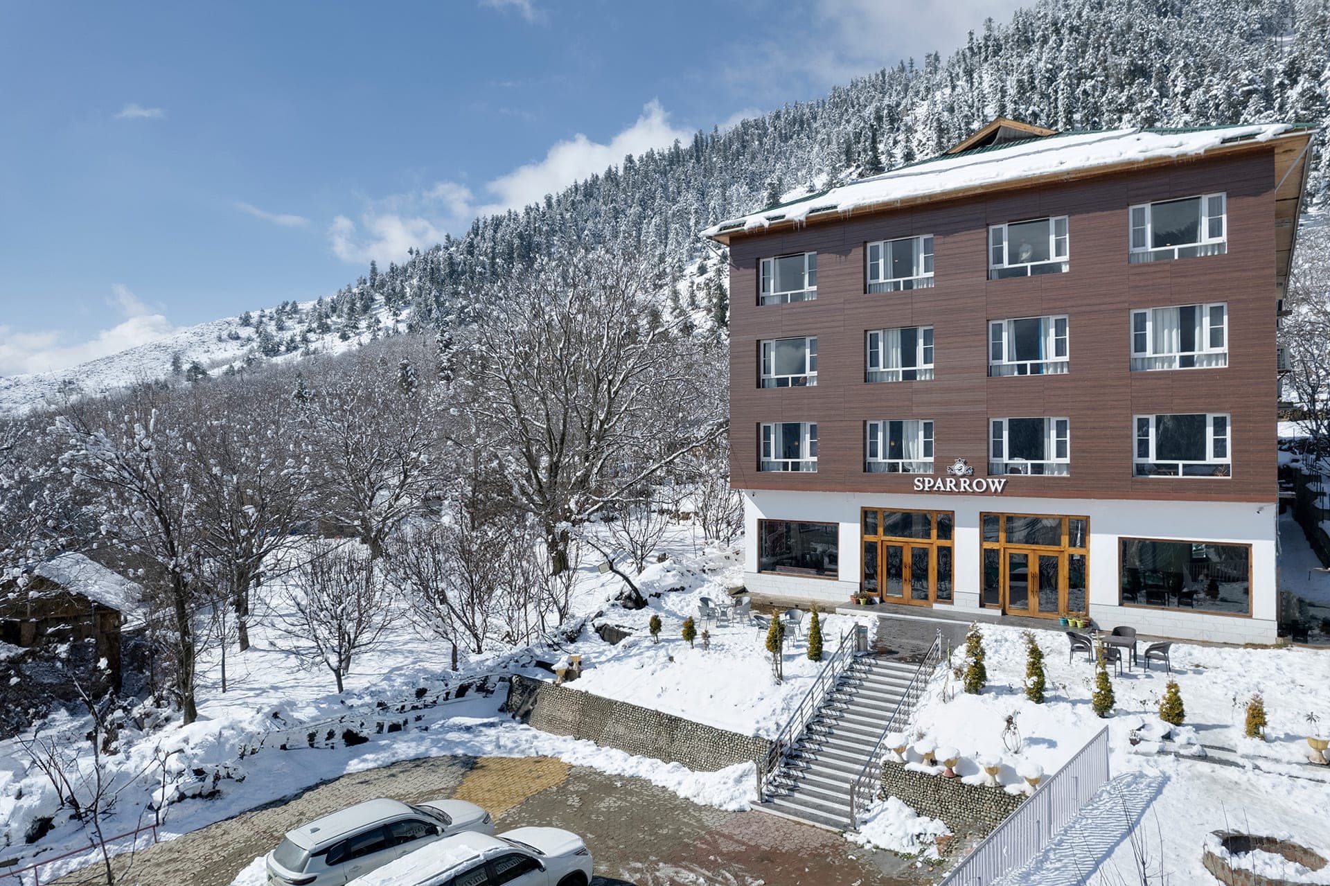 Hotel Sparrow exterior in the snow under a clear blue sky
