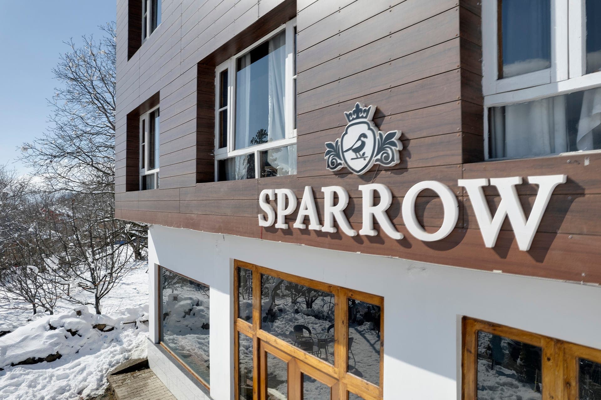 Hotel Sparrow signage and crest detail on the facade