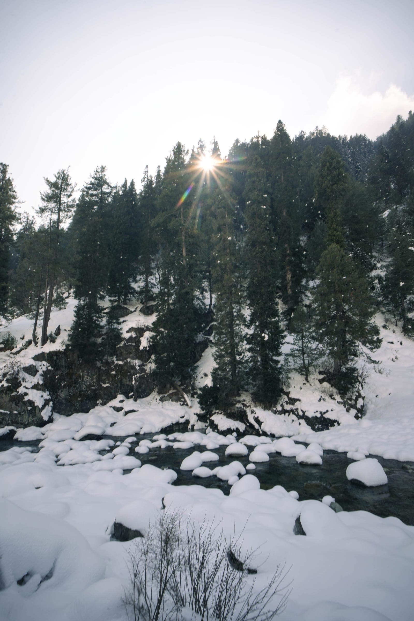 Snow-covered riverbank in Pahalgam, Kashmir
