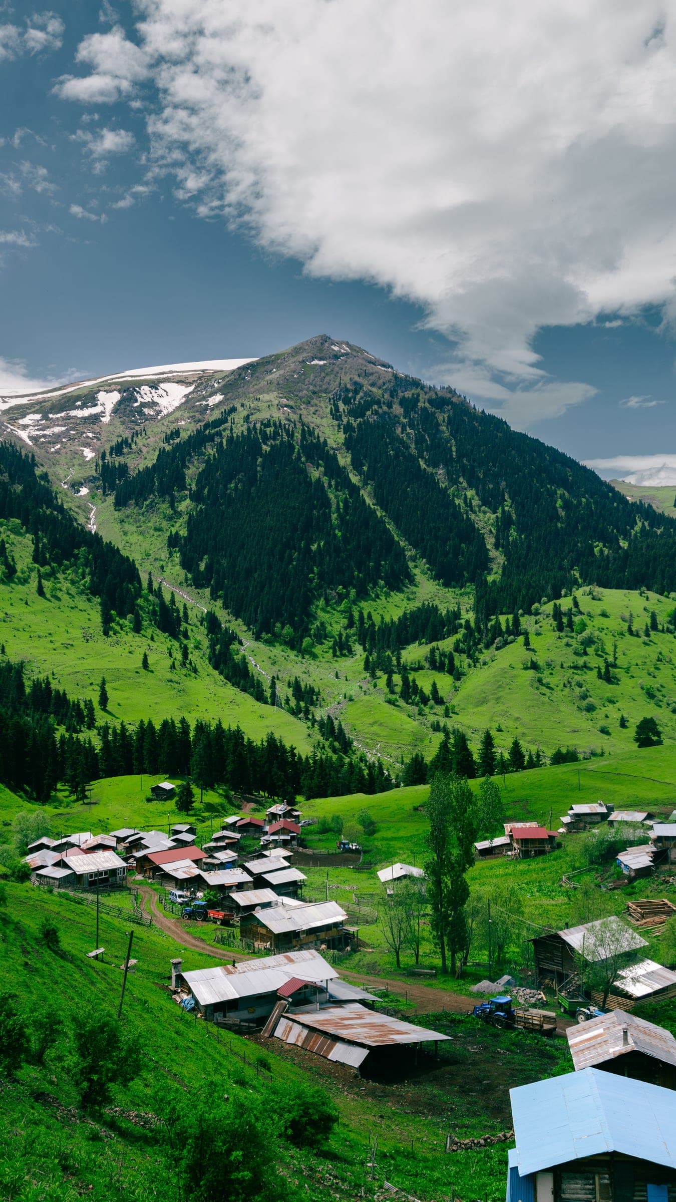 Green mountain slope and village near Pahalgam