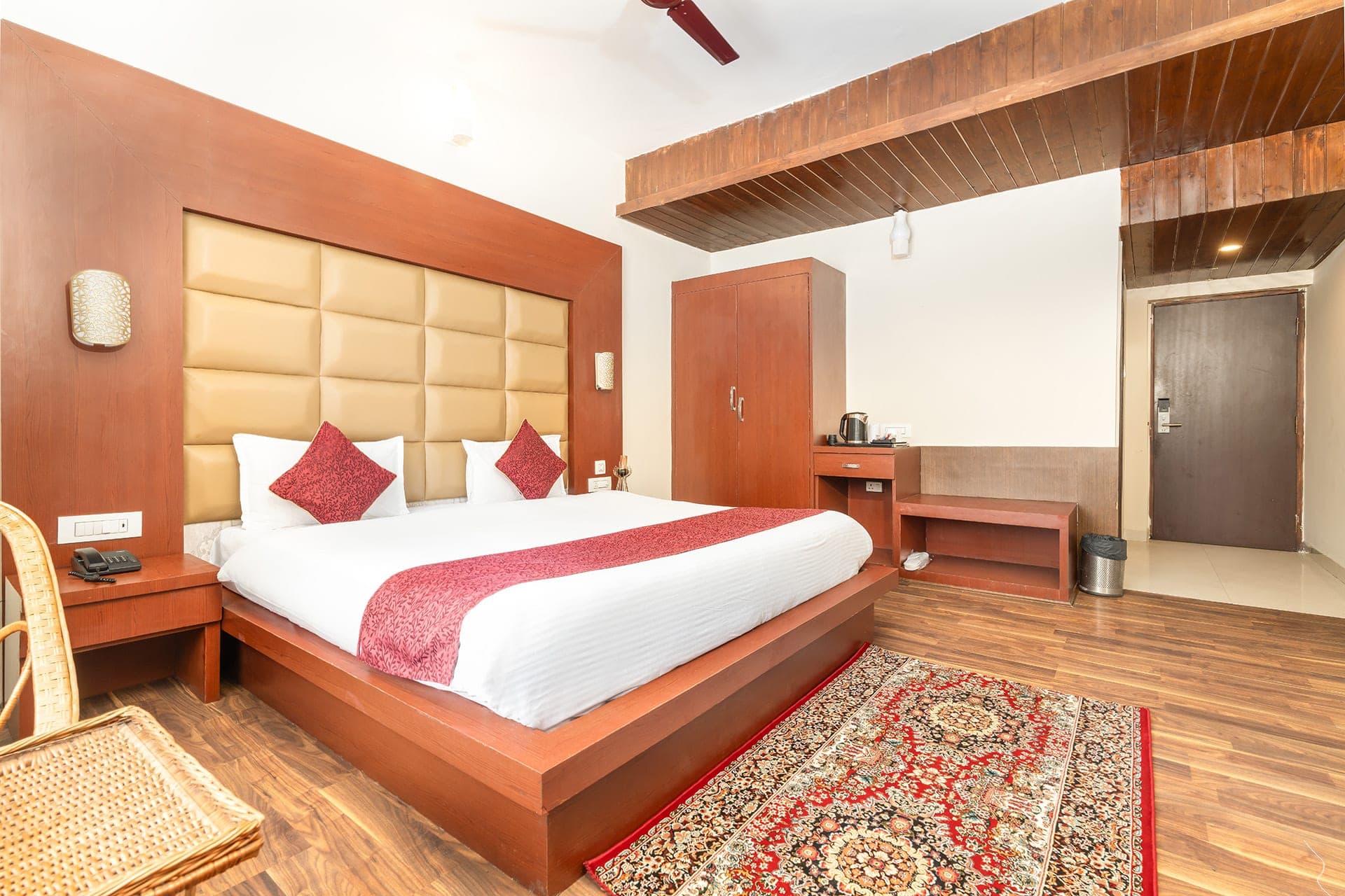 Deluxe Premier room at Hotel Sparrow with warm wood tones and village view