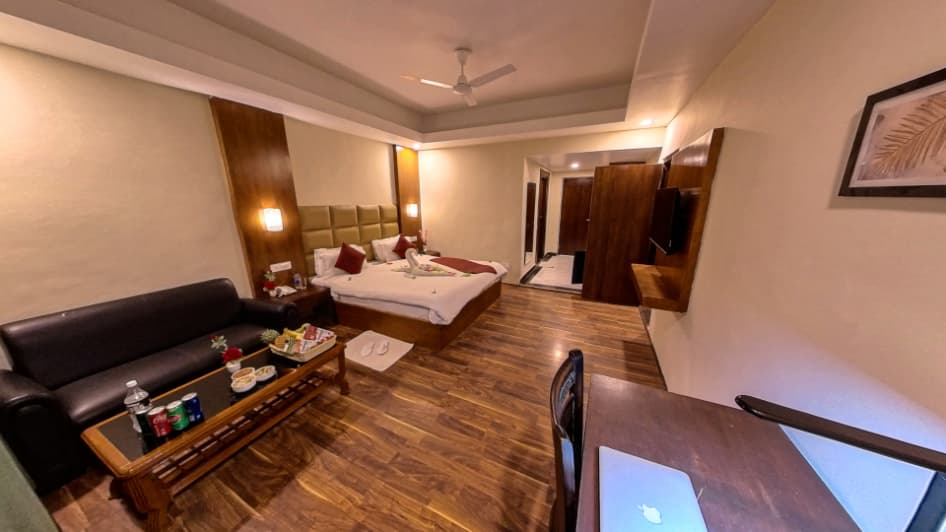 Deluxe Premier room at Hotel Sparrow with warm wood tones and village view